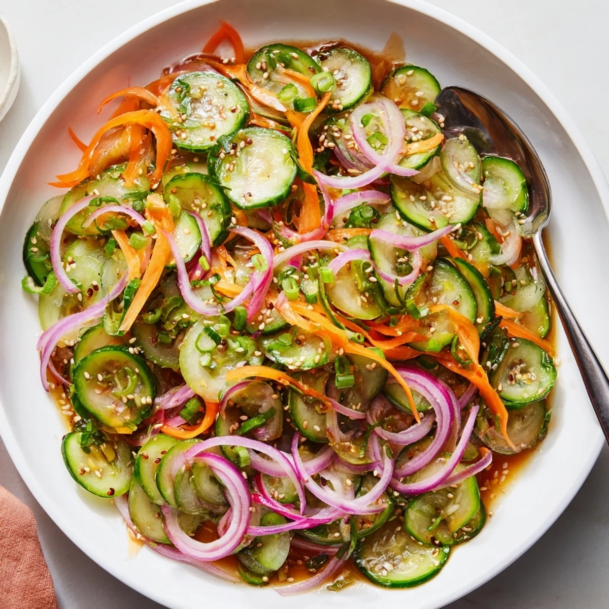 Vibrant Cucumber Salad Remix showcasing fresh produce and Asian-inspired flavors in a bowl.  