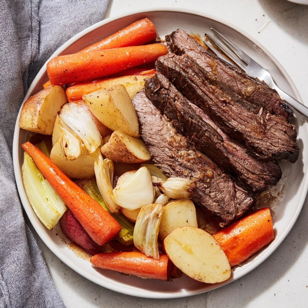 Slow-cooked Sunday Pot Roast served with golden roasted veggies for a cozy dinner.  