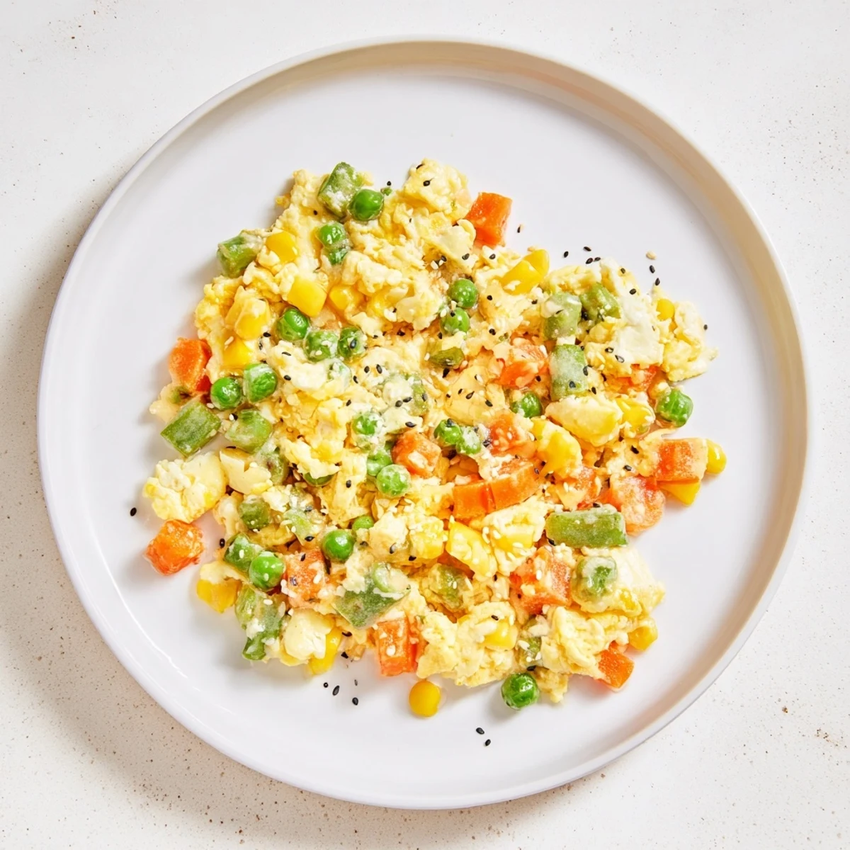 A close-up shot of golden-brown Frozen Veggie Fried Rice garnished with fresh green onions.