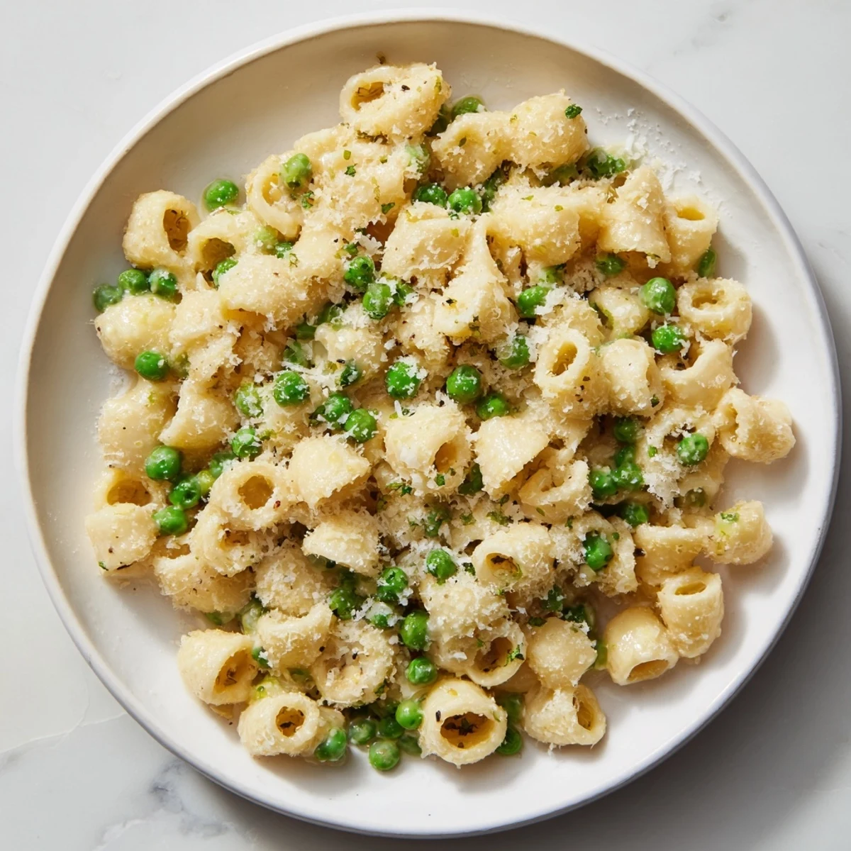 Steaming bowl of Macaroni & Peas, a creamy, comforting classic with Parmesan.