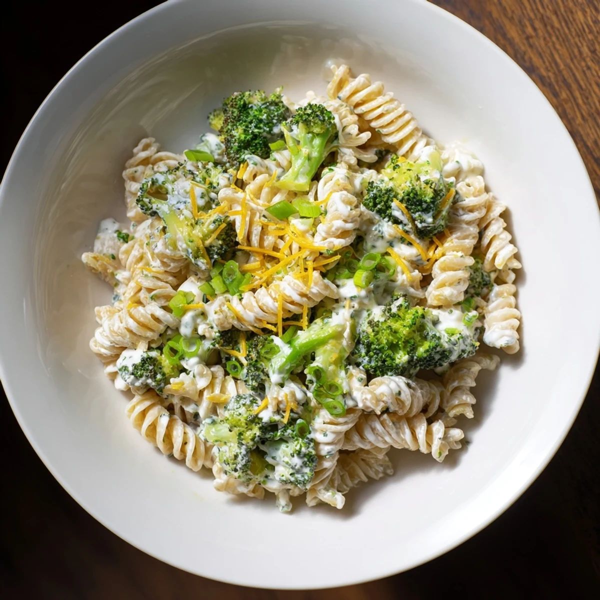 A bowl of Green Goddess Broccoli Cheddar One-Pot Pasta, garnished with fresh herbs, ready to serve perfectly.