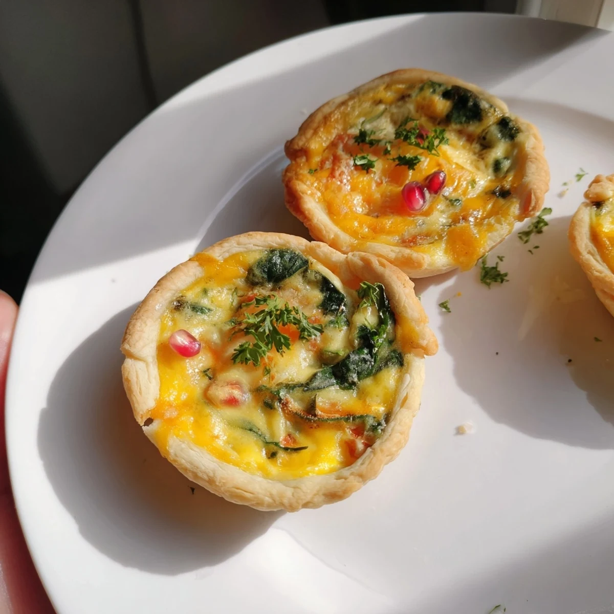 Imagine a visually striking arrangement: warm, savory mini quiche bites in a Christmas tree shape.