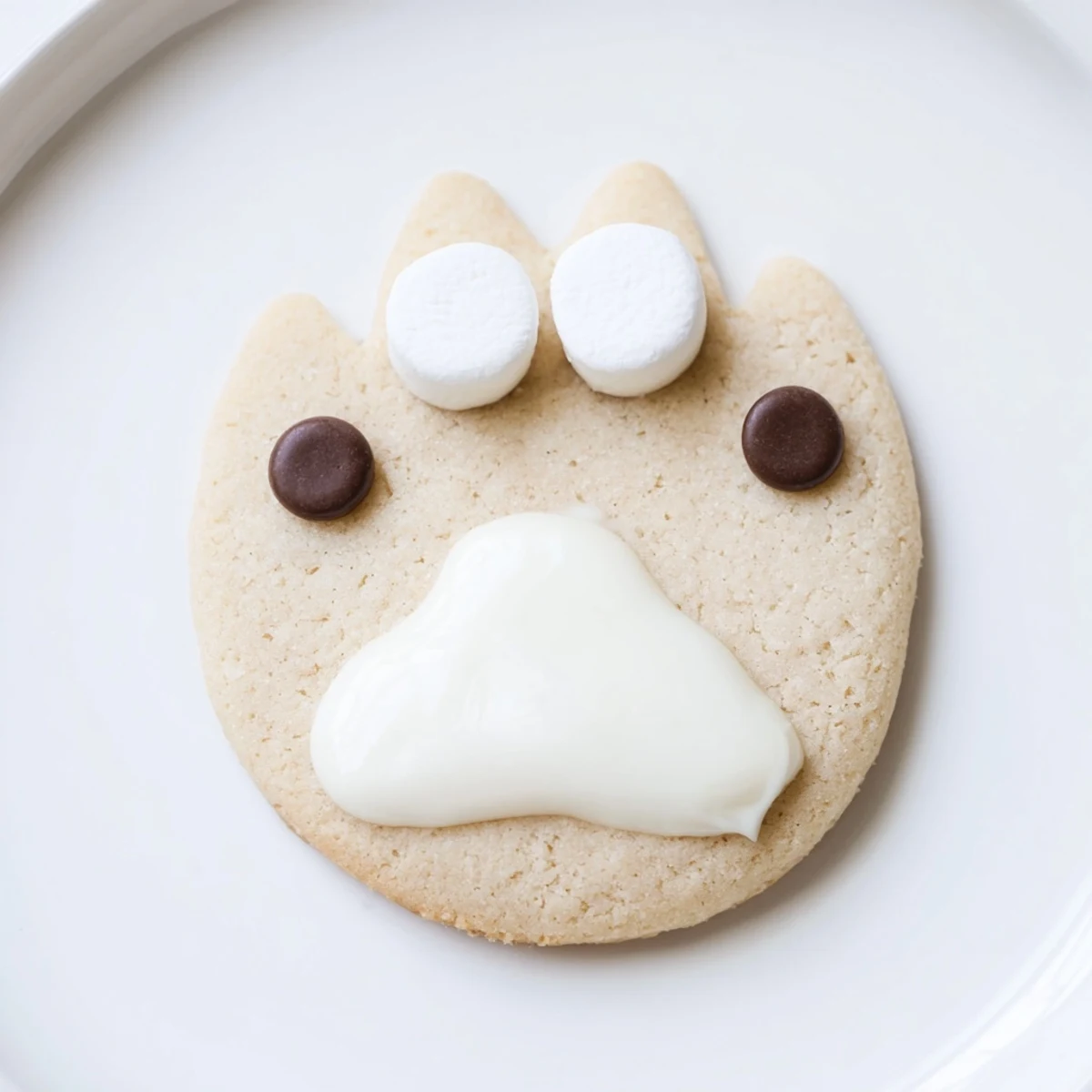 Freshly baked, beautifully decorated Polar Bear Paw Print Cookies, ideal for a children's winter wonderland party.