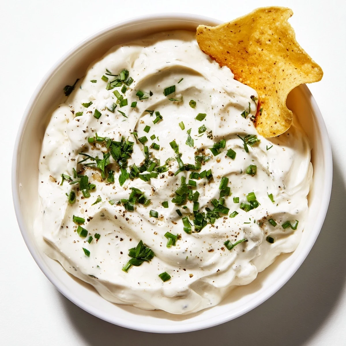 Bright green chives top creamy Veggie Ranch Dip, ready to be scooped with colorful vegetable sticks.