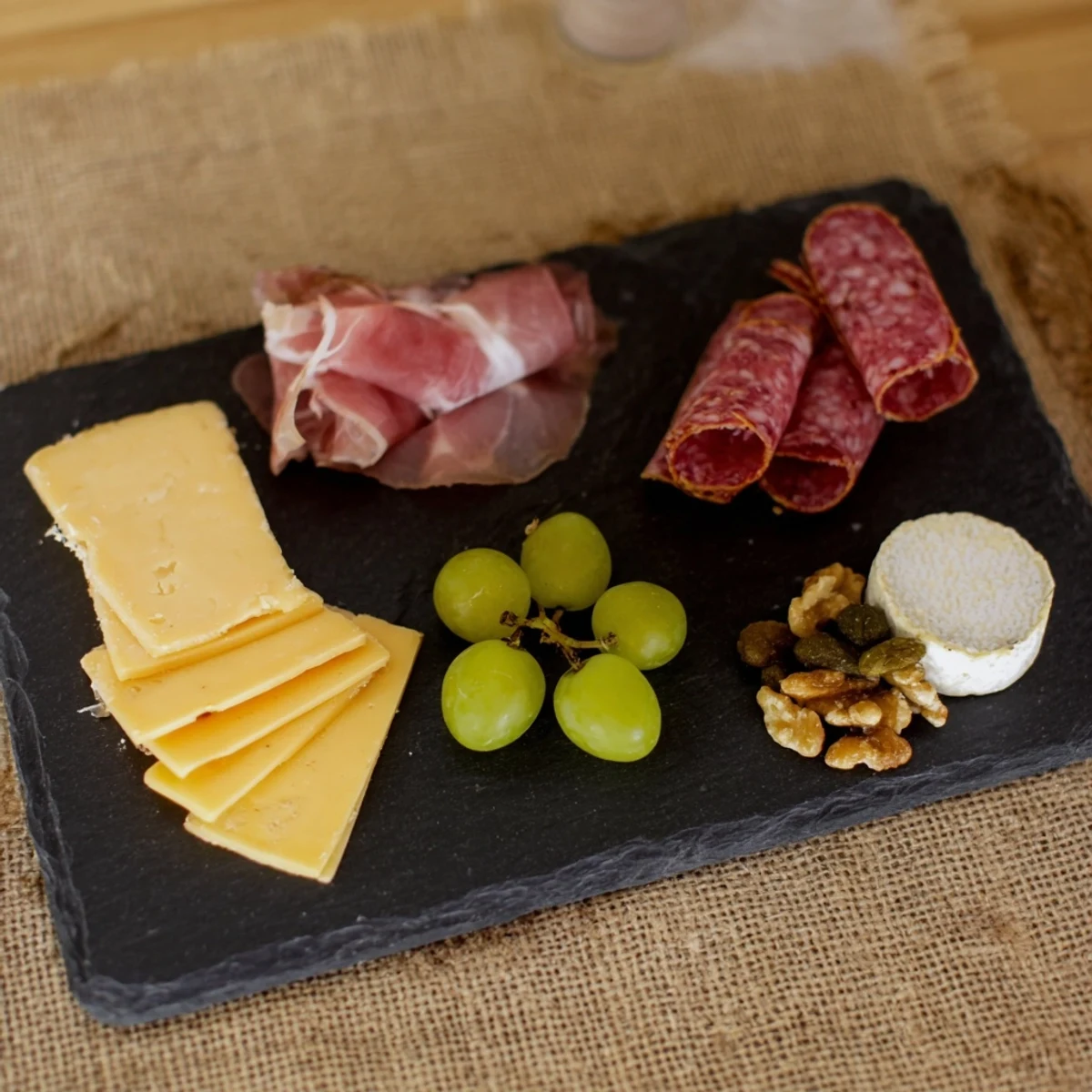 Enjoy this easy Charcuterie Board for One: a solo treat with cheese, meats, and fresh grapes.