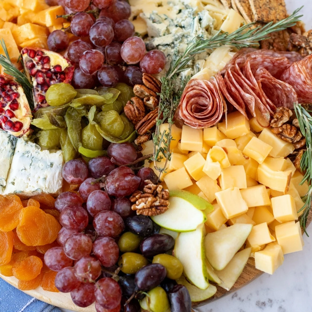 A beautifully arranged Sleigh Ride Charcuterie board overflowing with cheeses, meats, and seasonal winter fruit.
