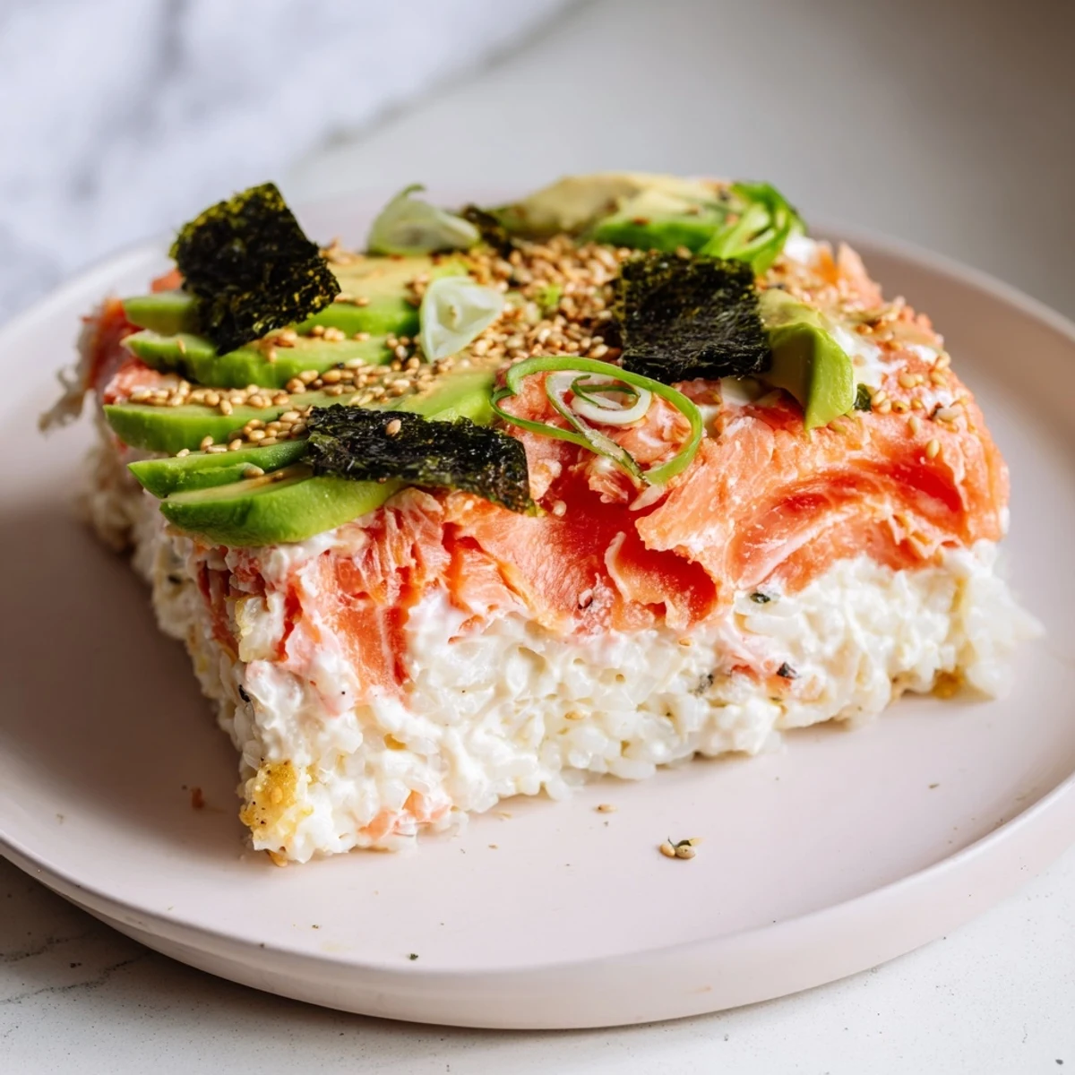 Warm sushi bake casserole bubbling in a baking dish, ready to be sliced and served.