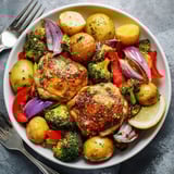 Aromatic Lazy Gourmet Chicken & Vegetable One-Pot served with fresh parsley and lemon wedges.  