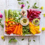 A beautifully arranged Vegan Global Gardener Platter: vibrant fruits, fresh vegetables, and delicious plant-based dips.
