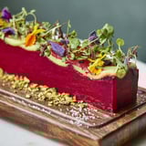 A visually stunning photo of The Modernist Stripe, showcasing colorful layered purées and artful garnishes.