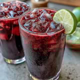 Creamy tropical Dragon Drink Refresher featuring dragon fruit, coconut milk, and lime, perfect for a refreshing summer sip.