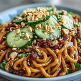 Vivid photo of Cold Peanut Sesame Noodles, tossed with crunchy peanuts and fresh scallions.