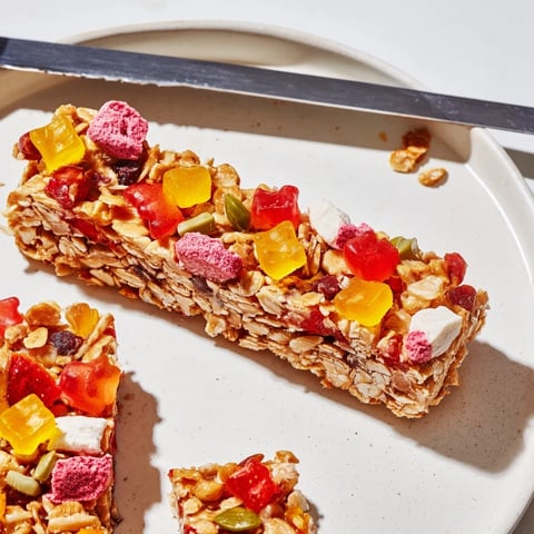 Colorful homemade gummies and freeze-dried candy topping delightful DIY snack bars.  