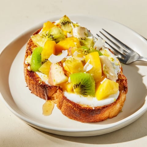 Vibrant Yogurt-Custard Toast topped with tropical fruits for a refreshing breakfast.  