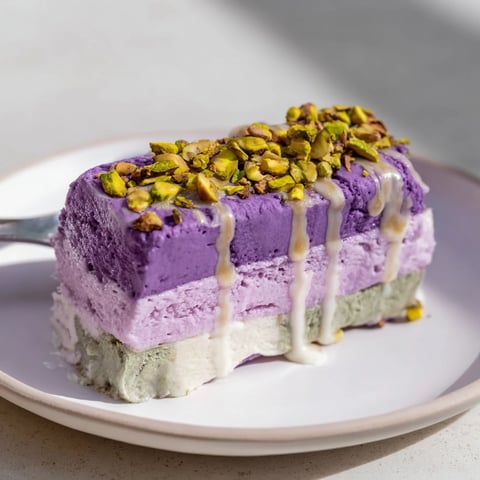 Creamy ube and pistachio ice cream bars topped with chopped pistachios.  