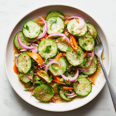 Cucumber Salad Remix with crunchy veggies and a savory sesame dressing drizzled on top.  