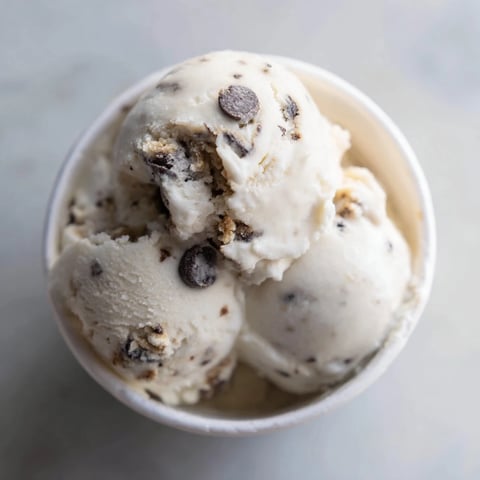 Creamy Cottage Cheese Ice Cream with Cookie Dough, drizzled with chocolate chips and sweetness.