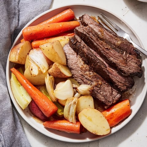 Slow-cooked Sunday Pot Roast served with golden roasted veggies for a cozy dinner.  