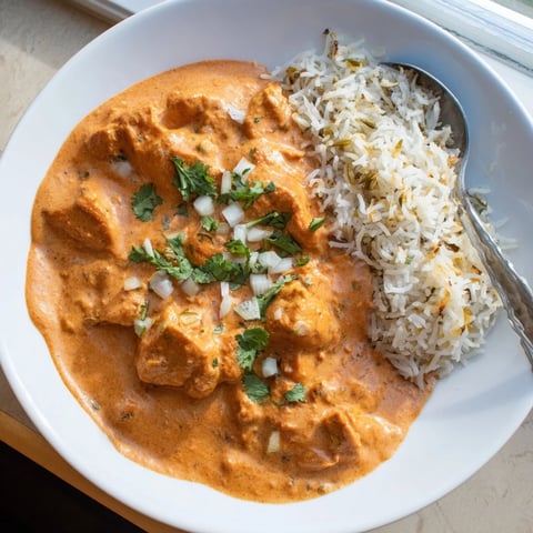 Tender butter chicken simmered in creamy tomato sauce served with fragrant rice pilaf.  