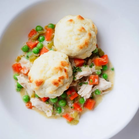 Chicken and Dumplings Casserole, bubbling hot, filled with fluffy dumplings and a creamy, savory sauce.
