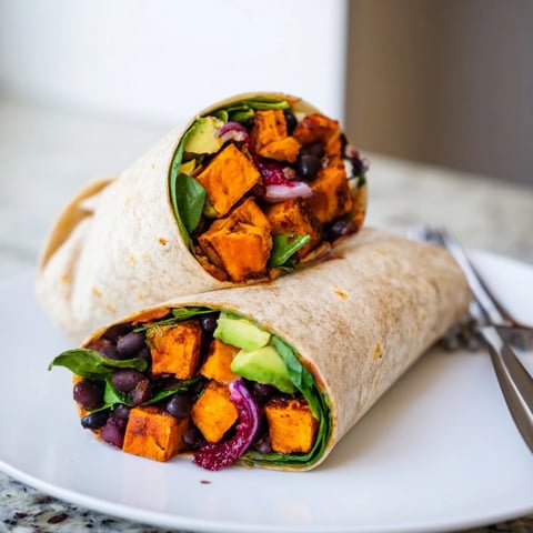 Savory Roasted Sweet Potato & Black Bean Holiday Wrap, brimming with colorful filling, ready to eat.