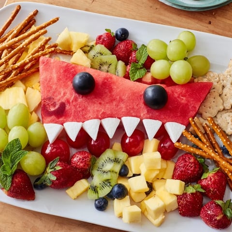 Vibrant Watermelon Wave Shark Snack Board features a carved watermelon shark and fresh summer fruits.