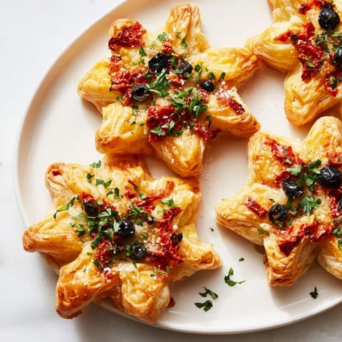 Golden-brown Olive and Sundried Tomato Star Garland, a delightful appetizer ready to serve with sparkling wine.