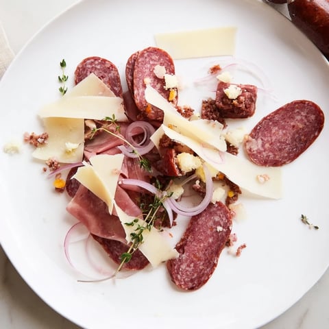The Burlap & Lace appetizer features rustic meats and shaved cheeses beautifully arranged on a wooden board.