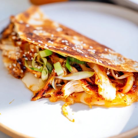 Golden-brown Korean BBQ Chicken Wrap Grilled Cheese, oozing melted cheese and savory chicken filling.