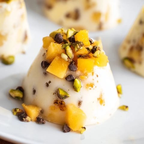 Frozen Peach Yogurt Bites, frozen solid and topped with nuts, perfect as a refreshing summer treat.