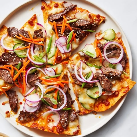 Golden, bubbly Korean BBQ Nachos topped with fresh vegetables, ready to serve and enjoy.