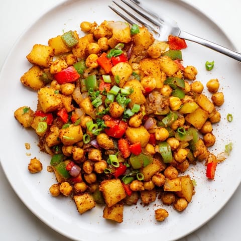 Savory Cajun Chickpea Breakfast Hash: Potatoes, peppers, and herbs offer a hearty aroma.