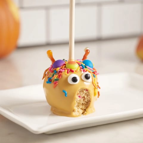 Deliciously moist cake pops, featuring apple-cinnamon with a caramel drizzle for Halloween fun.  