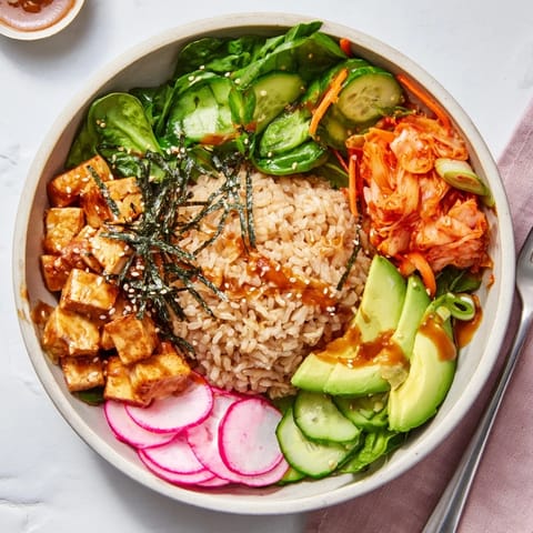 Colorful fermented vegetable bowl topped with kimchi, avocado, and a savory dressing.  