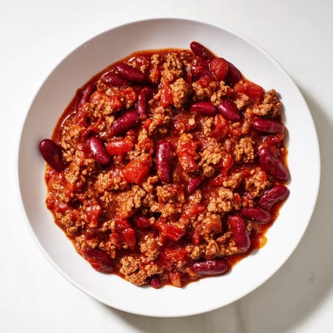 Slow cooker brimming with rich, savory The Secret 4-Ingredient Chili, perfect for a chilly evening meal.