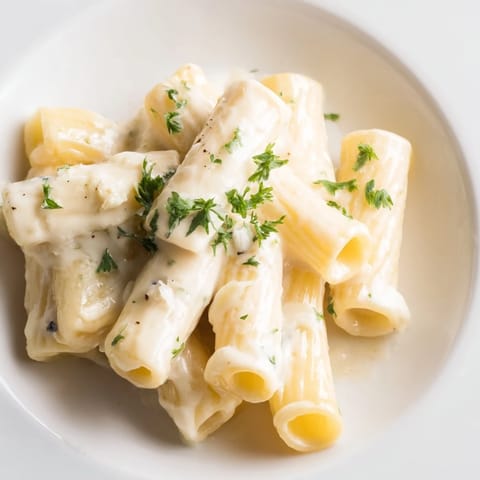 A wide shot reveals a generous bowl of the finished Creamy Milk Pasta One-Pot, ready to eat.