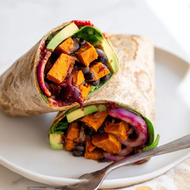 The delicious Roasted Sweet Potato & Black Bean Holiday Wrap, complete with optional fresh cilantro and avocado slices.