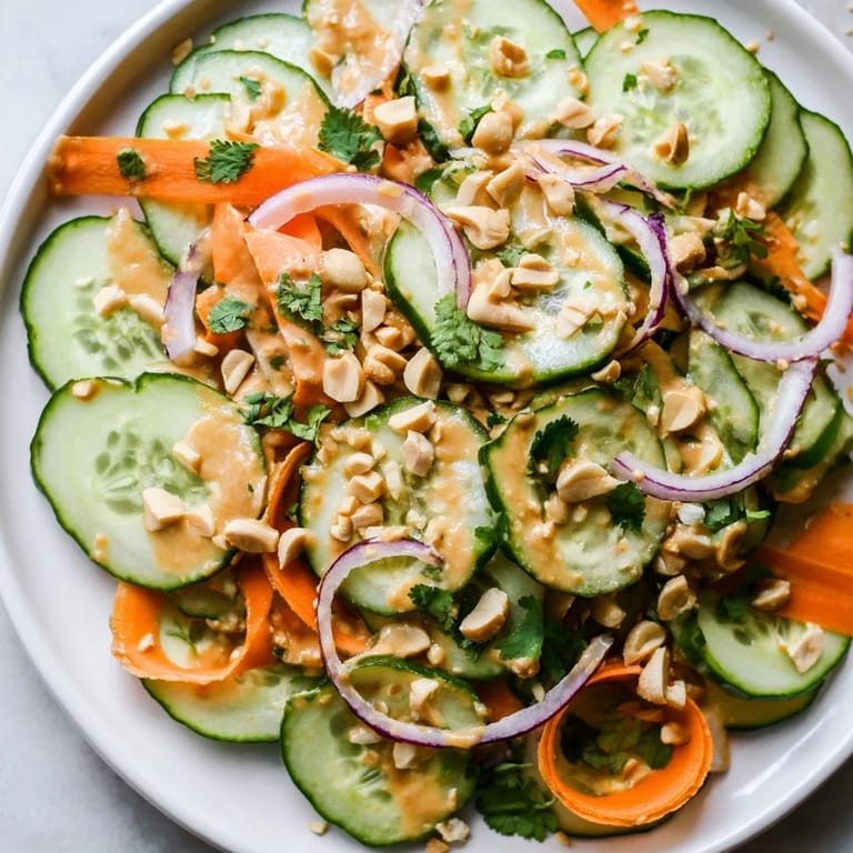 Close-up of the delicious Thai-Style Peanut Cucumber Salad, with crunchy peanuts and colorful veggies.