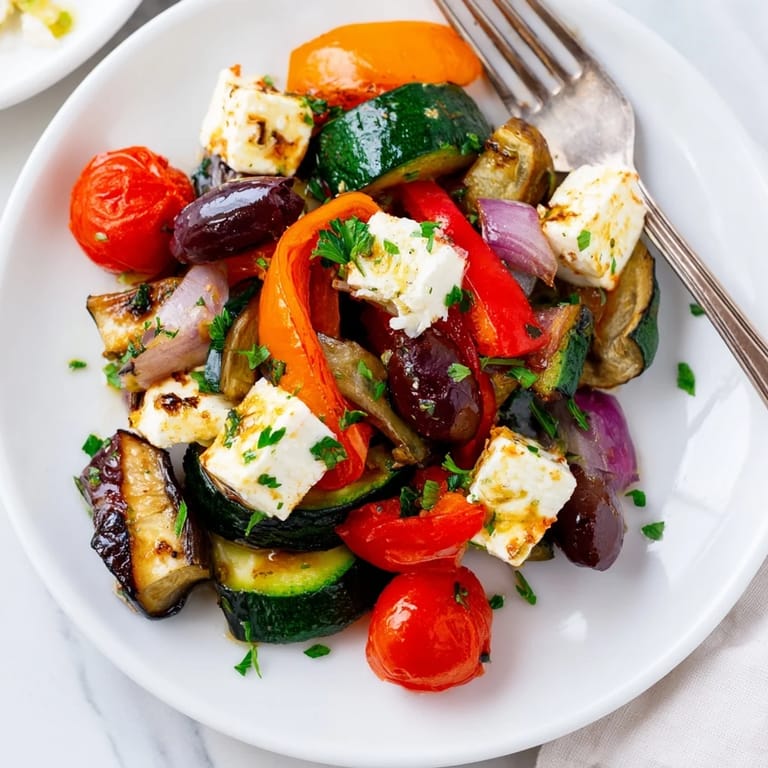 Golden roasted vegetables and Kalamata olives highlight this hearty Roasted Greek salad, served with crusty bread.