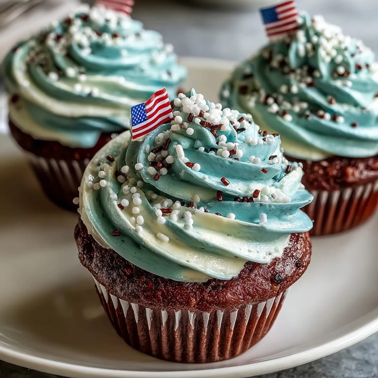 Festive Star-Spangled Banner Cupcakes topped with edible flags, ready for celebration.