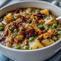 Slow Cooker Chicken Pot Pie Soup in a creamy, savory broth with tender chicken and hearty vegetables, perfect for cozy weeknight dinners.